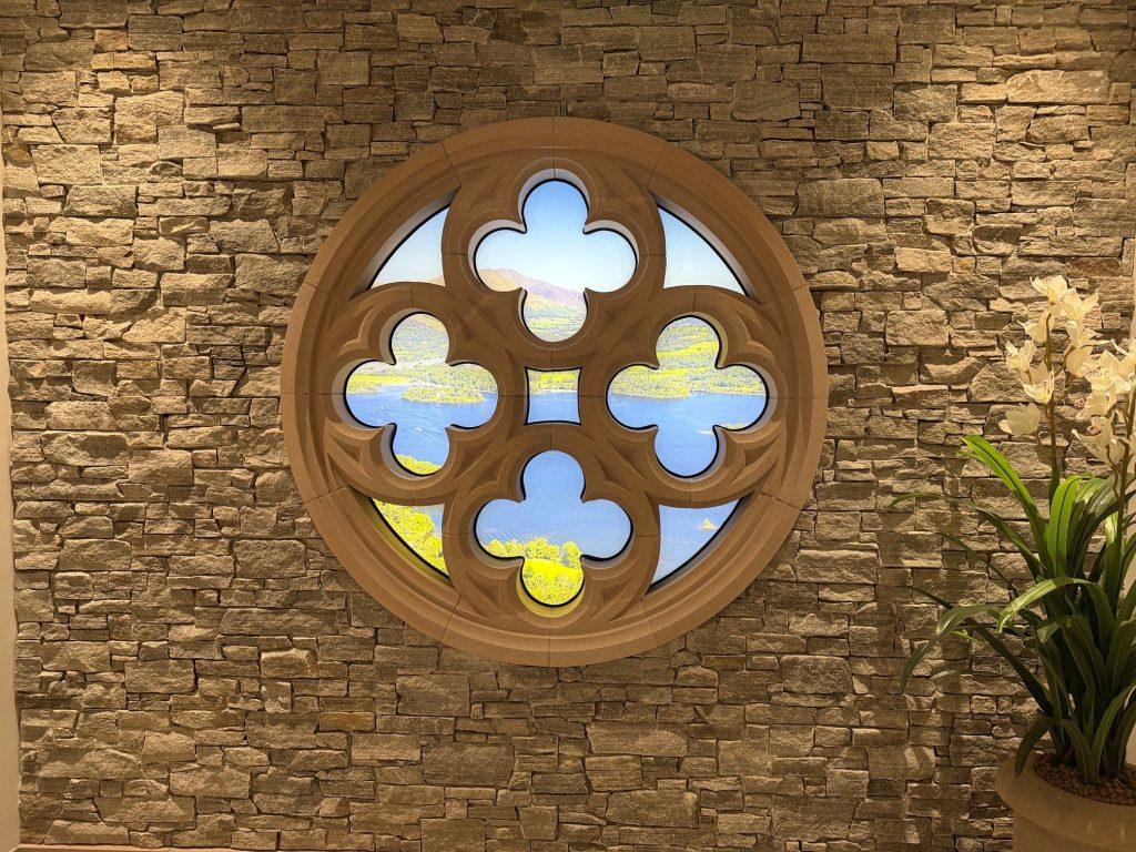 Wattscliffe sandstone rose window with the CS Plus+CLad system, looking out over lake Derwent in the Cumbrian Stone Showroom